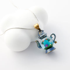 	alt="Close-up of Dream Distiller Necklace showing teapot pendant with resin dewdrop"