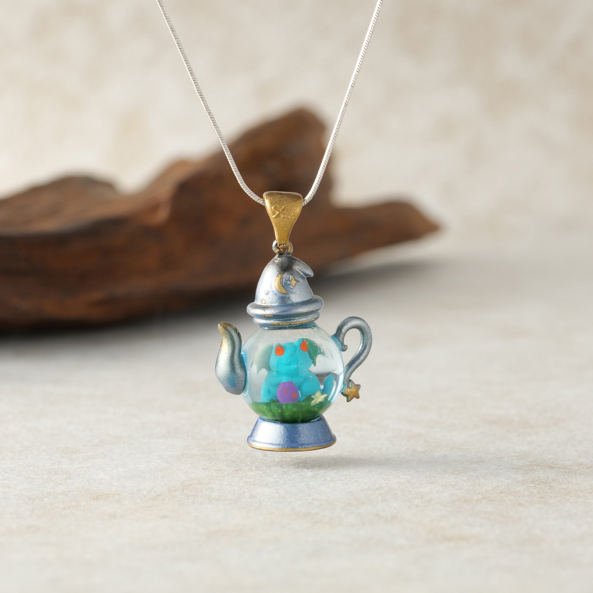 	alt="Dream Distiller Necklace styled with purple flowers"