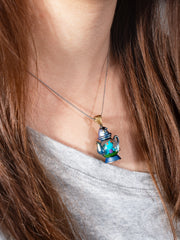 alt="Dream Distiller Necklace worn close-up with vibrant teapot design"